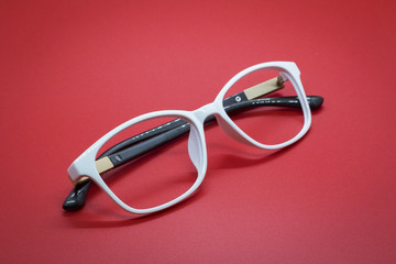 Modern fashionable spectacles on red background, Glasses