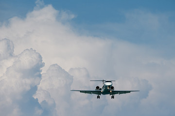 Fototapeta na wymiar Private jet aircraft fly in front of rain cloud