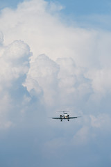 Private jet aircraft fly in front of rain cloud