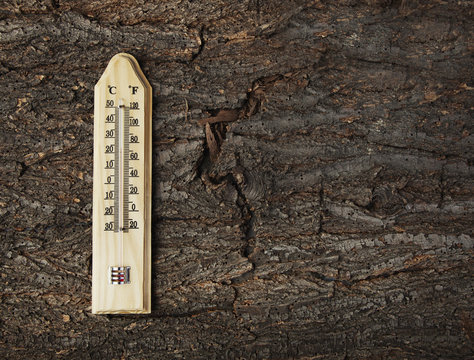 Thermometer on a old wooden background photo