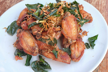 Fried chicken wings in white dish. Buffalo chicken wings. Chicken wings with spicy food and thai herb. (Top View)