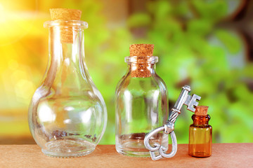 Old fashioned bottles with vintage key green background