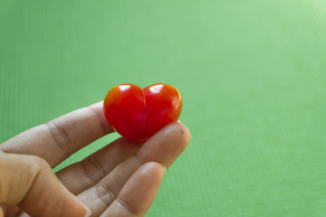 red heart in hands on green background,valentine's day.
