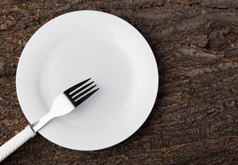 Plate white and fork empty wooden table top view
