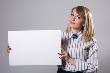 Pretty business woman holding a blank sign