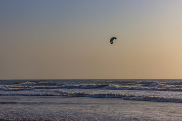 Kitesurf at sea on a sunset, Arambol beach, Goa, India