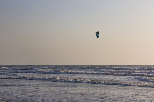 Kitesurf at sea on a sunset, Arambol beach, Goa, India