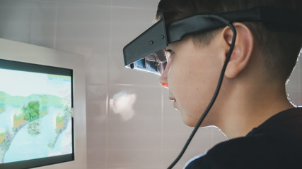 Ophthalmology - child checks eyes with stereo glasses and monitor