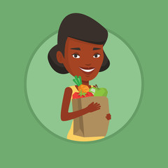 Happy woman holding grocery shopping bag.