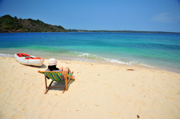 Fototapeta na wymiar Woman Relaxing on Summer Beach