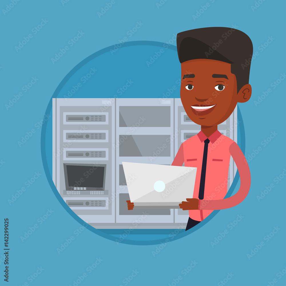 Poster engineer working on laptop in network server room.