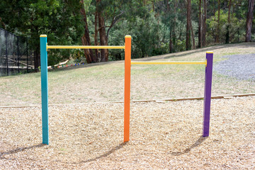 Fototapeta na wymiar Little colourful horizontal bar in childrens play area in the park.