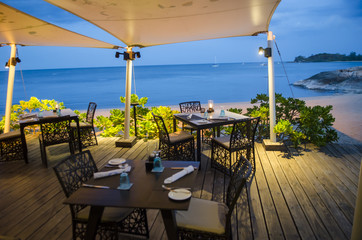 Table setting at beach restaurant in twilight time.