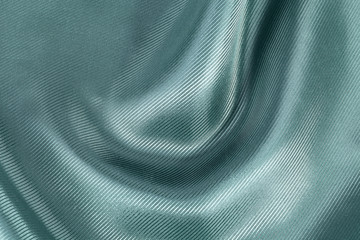 Silk background, texture of green ribbed  shiny fabric