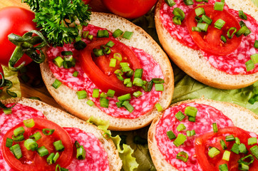 Sandwich with sausage and tomatoes.