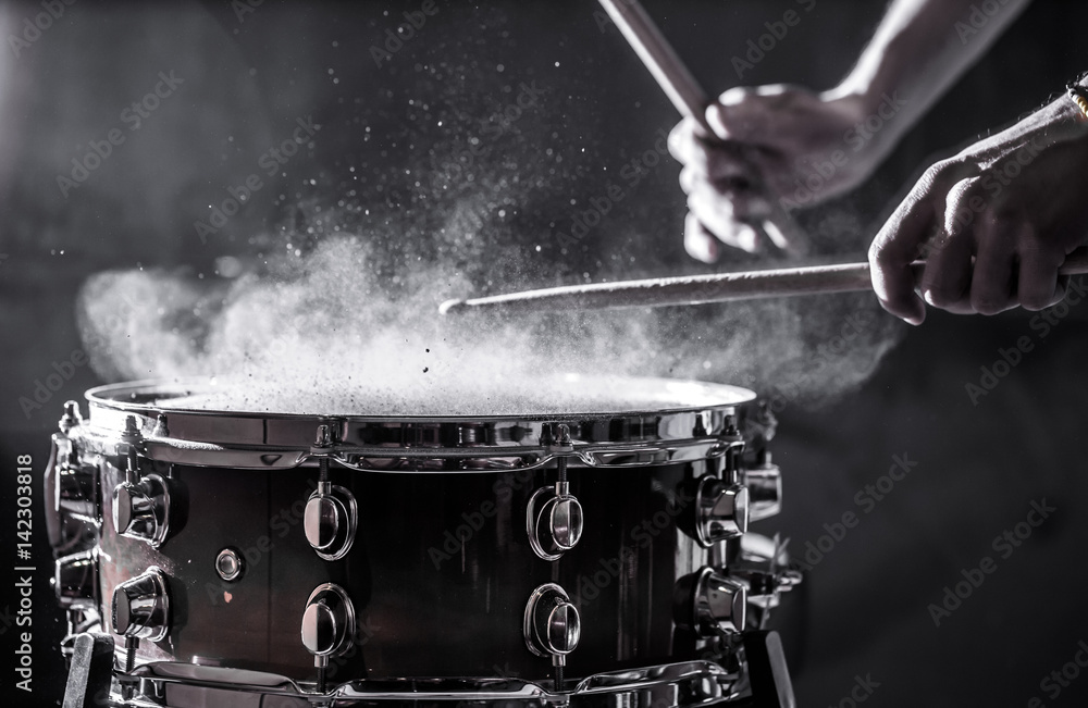 Wall mural man plays musical percussion instrument with sticks, a musical concept, beautiful lighting on the stage