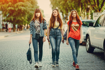 three young girls walking in the park