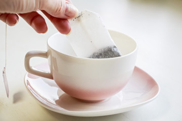 Tea bag put in white ceramic teacup