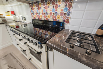 Kitchen interior with modern appliances, oven,gas stove,induction cooktop