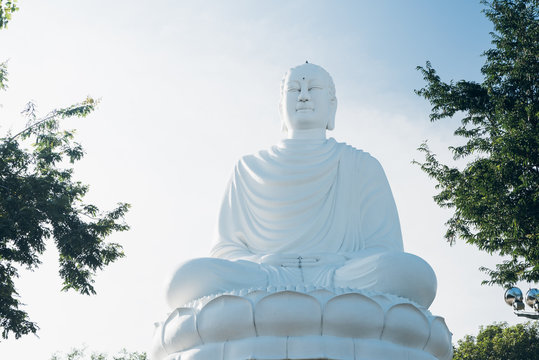 White Buddha Statue at Long Son Pagoda. Big Buddha Statue in Nha Trang, Vietnam. Sunny day, blue sky