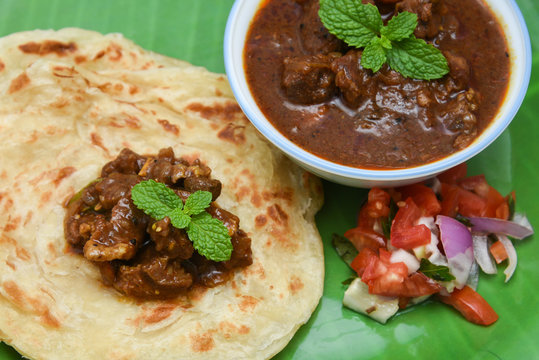 Kerala parathas / porotta / roti / parotta / barotta/ naan layered flatbread made from maida or whole wheat flour. Eat with spicy Asian chicken or beef or egg curry gravy. breakfast dish. Indian food.
