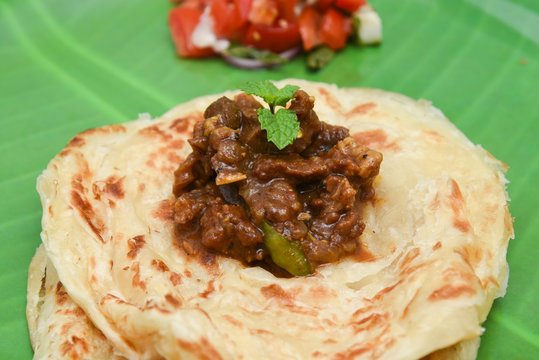 Kerala parathas / porotta / roti / parotta / barotta/ naan layered flatbread made from maida or whole wheat flour. Eat with spicy Asian chicken or beef or egg curry gravy. breakfast dish. Indian food.