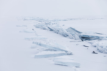 Fototapeta na wymiar Turquoise ice floe. Winter Baikal lake landscape. Ice-drift