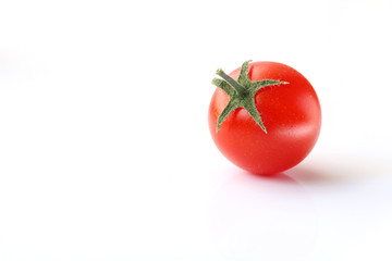red cherry tomato on white