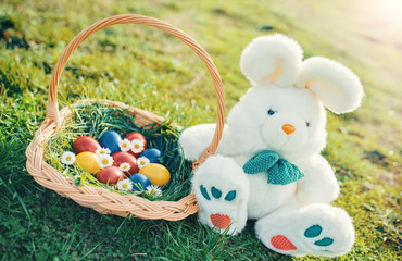 Colorful Easter eggs and bunny in the grass
