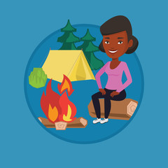 Fototapeta premium Woman sitting on log near campfire in the camping.