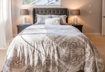 contemporary designer bedroom with paisley bedspread and nightstands