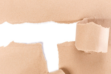 Hole ripped in brown paper on white background.