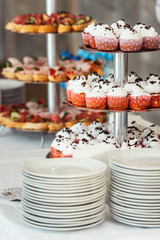 Pink craemy cakes on a stand. Close Up