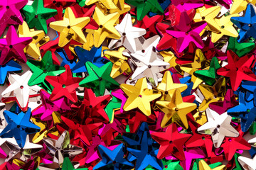Shiny colorful sequins of  star shape as festive party texture background