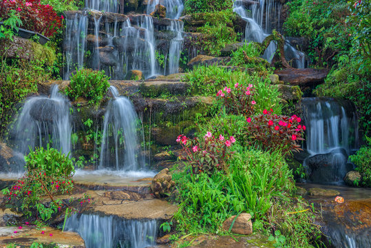 beautiful landscaping with waterfall and flowers