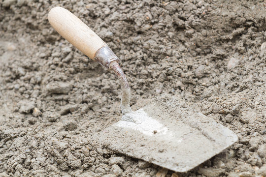 Construction throwel  tool on a sand / cement.
