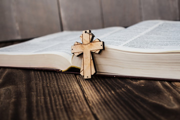 christian cross and bivle on wooden background