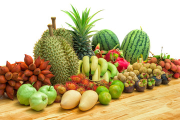Fresh mixed fruits on wood table isolated on white background.