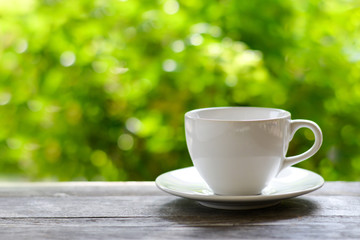 Close up white coffee cup on the table at morning time