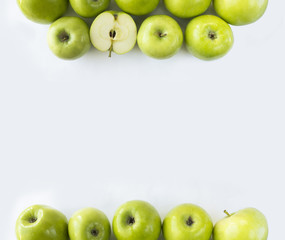 Horizontal seamless background with green apples. Fresh apples on a white background. Apples at border of image with copy space for text.