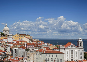 Fototapeta na wymiar Portugal, Lisbon . The observation deck Portas do Sol - a view of the old district of Alfama, with its winding streets , the Church of São Vicente de Fora and the Tagus River.