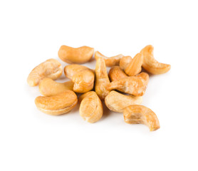 Pile of roasted cashew close-up isolated on white background