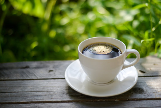 Cup of coffee on nature background.