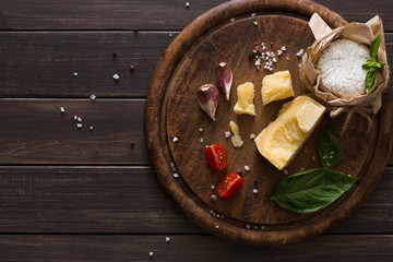 Cheese delikatessen closeup on rustic wood, brie and parmesan