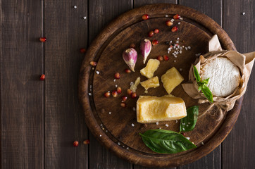 Cheese delikatessen closeup on rustic wood, brie and parmesan