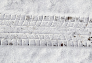 traces of cars on the road in winter