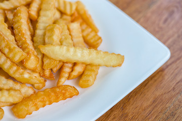 French fries with ketchup on wooden background.