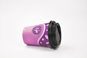 A violet paper coffee teacup with a lid on the white background.