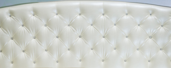 luxurious white leather sofa with pin jewelry accessories