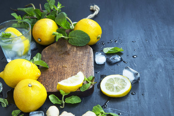 Fresh lemons  and mint on wooden board , soda and infused water drink ingredients